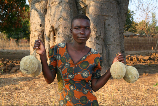 Woman holding baobab fruit